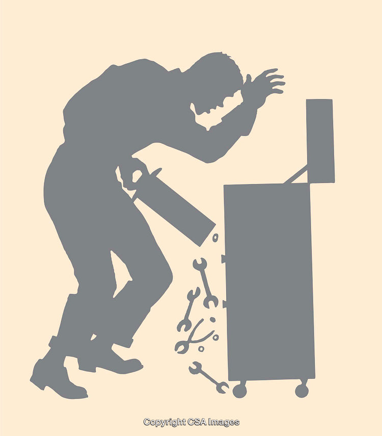 Silhouette of a Repairman Working With Tools Near a Toolbox