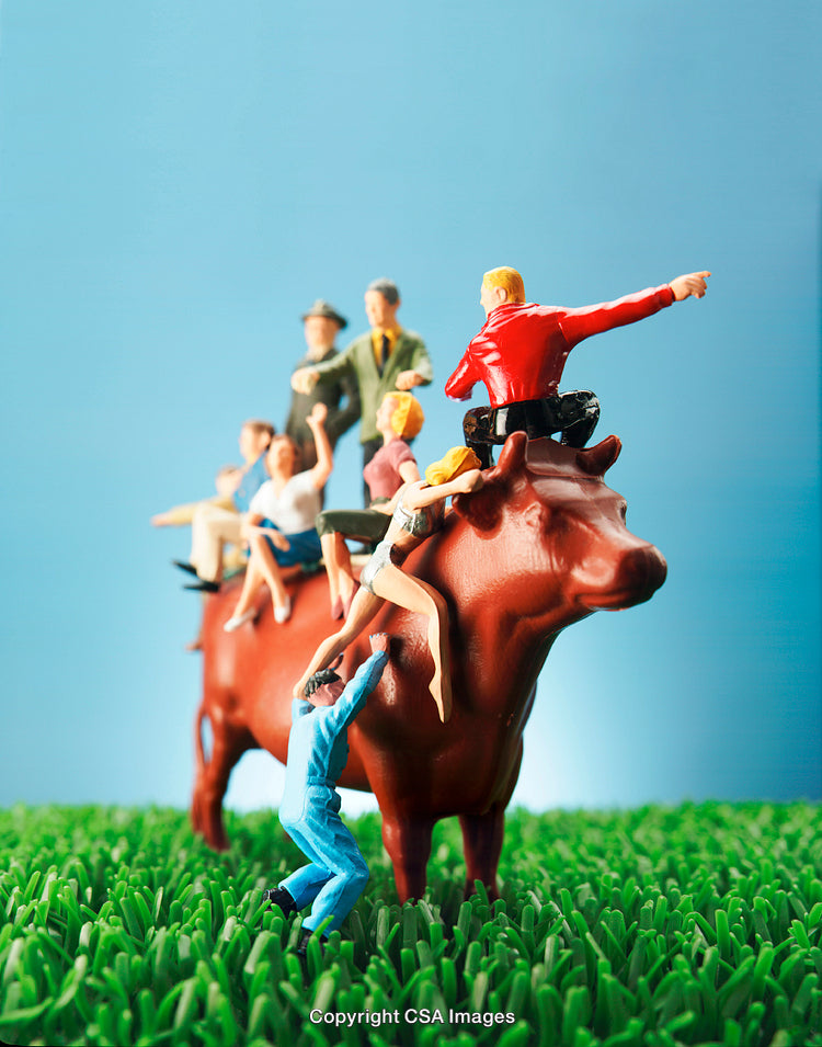 Miniature Figurines Climbing on Toy Cow Against a Vibrant Blue Background