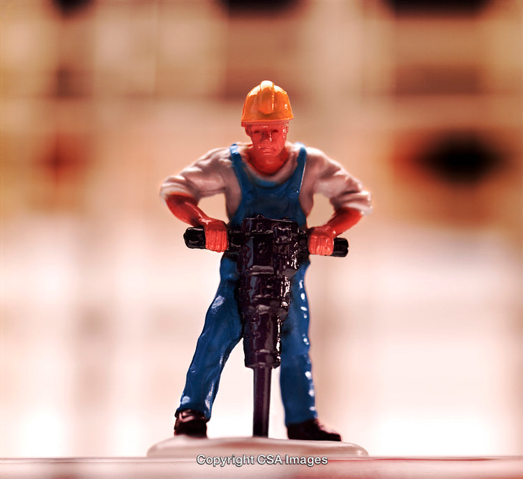 Construction Worker Toy Figure Using Jackhammer in Close-Up Detail