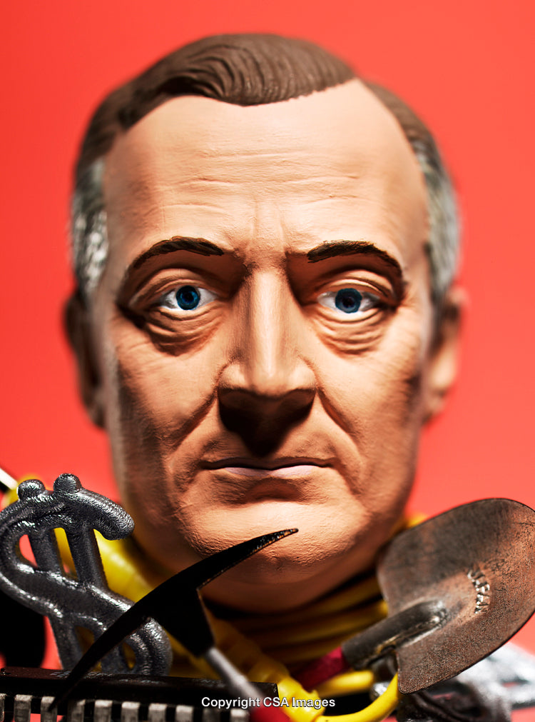 Close-Up of a Male Figurine With Bright Red Background and Dollar Symbol