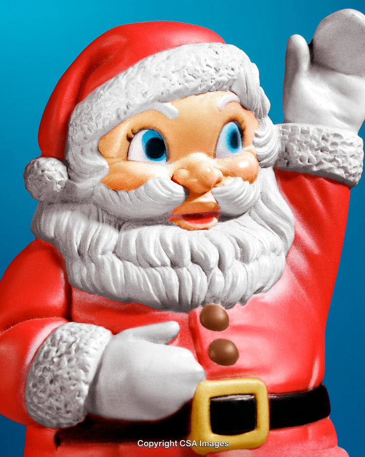 Festive Santa Claus Figurine Waving on Vibrant Blue Background