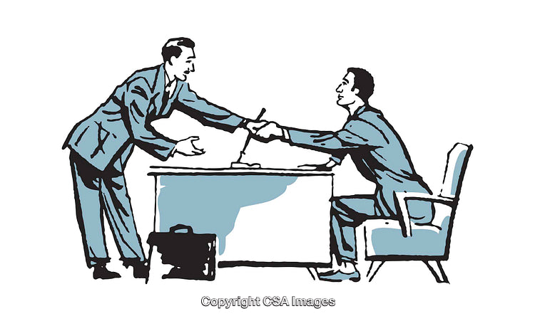 Two Business Professionals Shaking Hands During an Office Interaction
