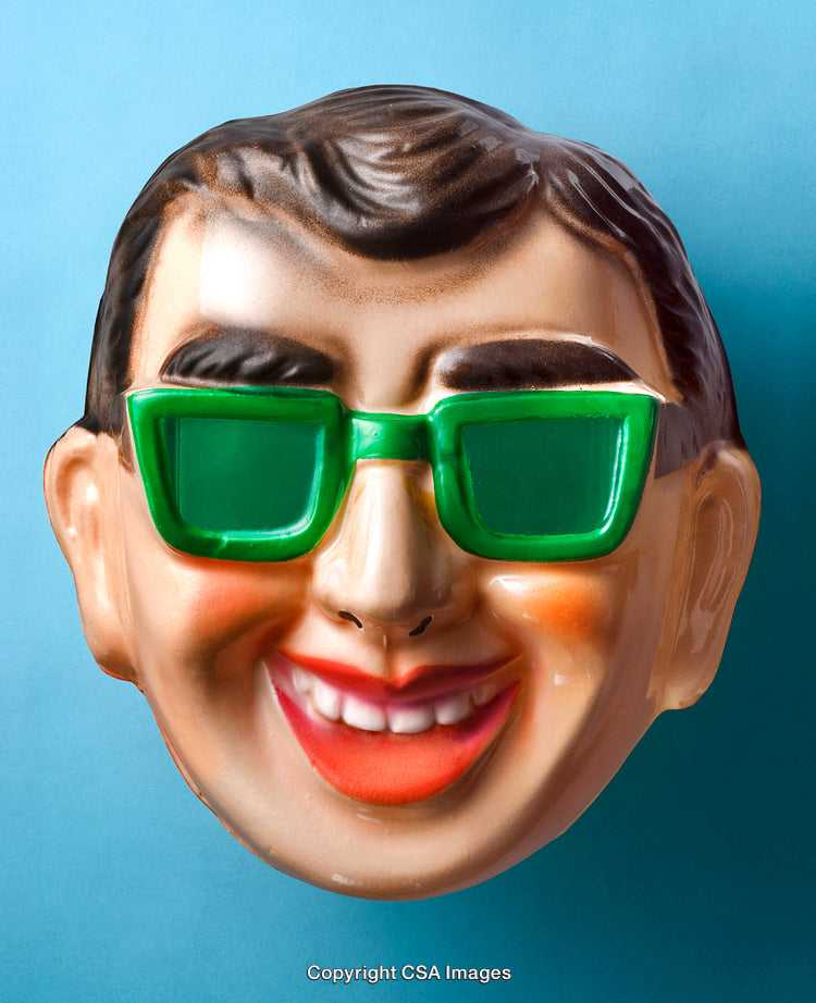 Close-Up of Vintage Plastic Mask with Green Glasses on Blue Background