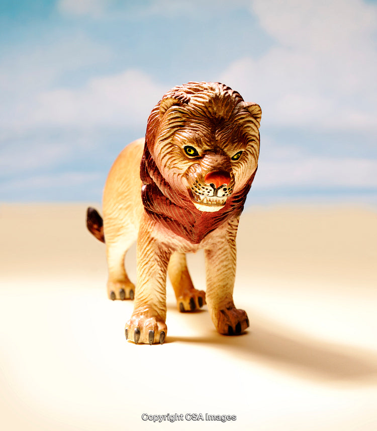 Close-Up of a Plastic Lion Figurine on a Light Background