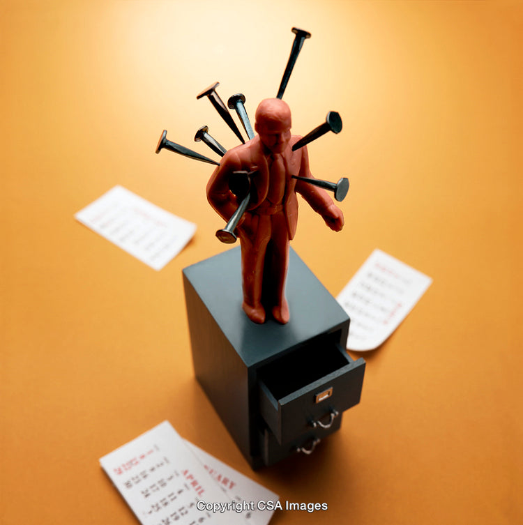 Red Figurine Pierced by Nails Sitting on a Dark Metal Drawer