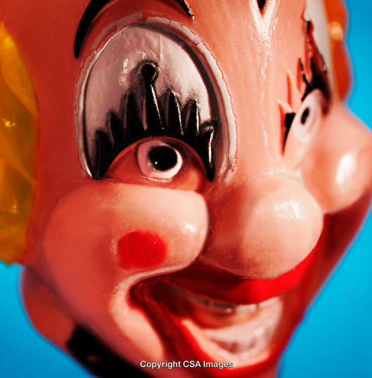 Close-Up of a Colorful Clown Mask Against a Blue Background