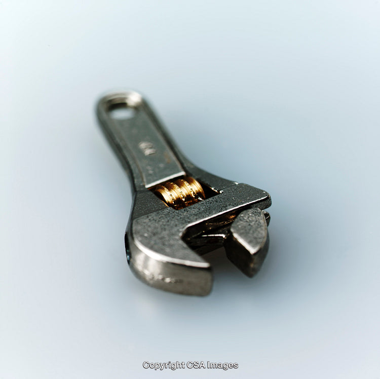 Close-Up View of an Adjustable Metallic Wrench on Isolated Background