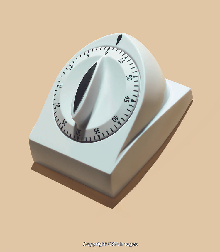 White Kitchen Timer Device Against a Neutral Background