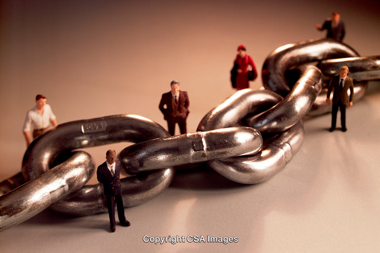 Miniature Business Figures with Chain Symbolizing Connection and Strength