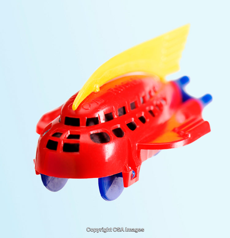 Vibrant Red Toy Airplane with Yellow Fins on a Light Background