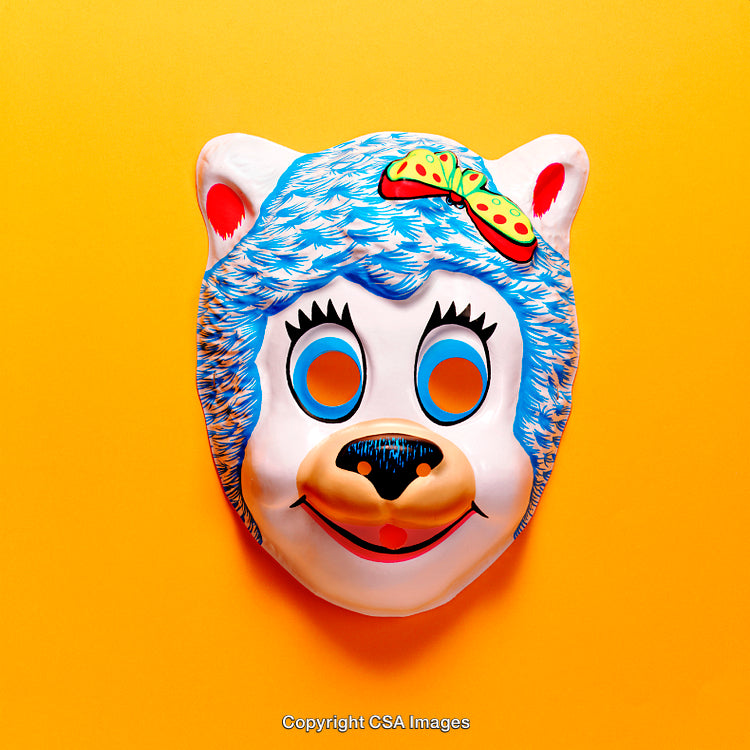 Colorful Bear Mask Against Bright Yellow Background in Studio Lighting