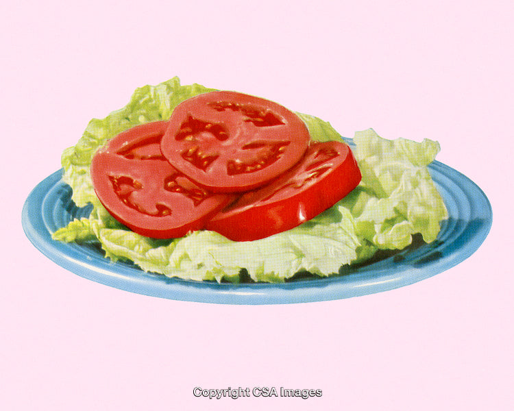 Plate with Sliced Tomatoes on Lettuce Against a Pink Background