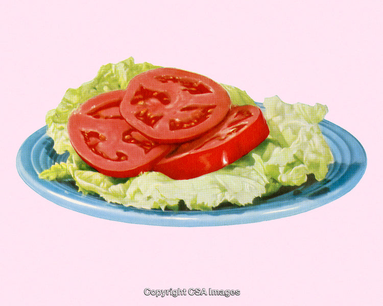 Plate with Sliced Tomatoes on Lettuce Against a Pink Background