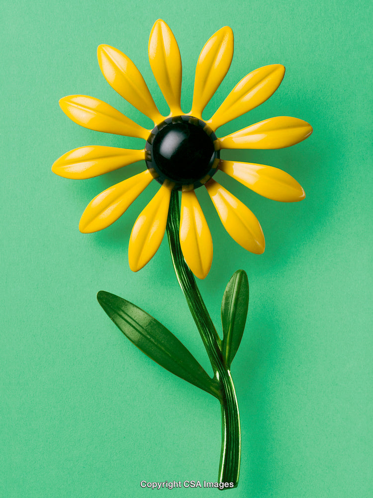 Bright Yellow Flower Toy on a Vibrant Green Background