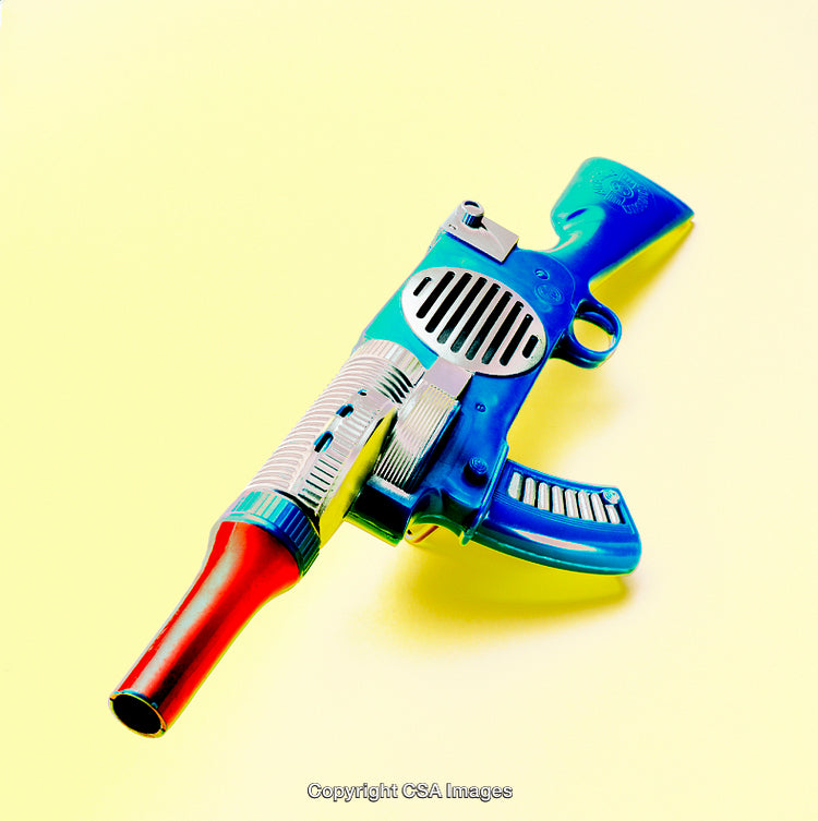 Brightly Colored Retro Toy Gun Against Yellow Background