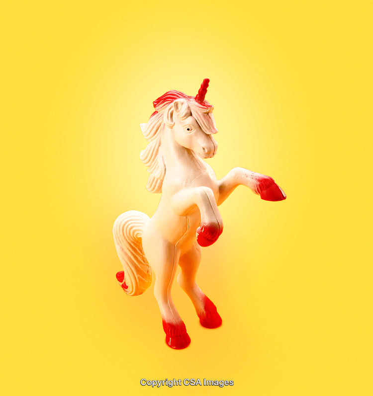 Colorful Toy Unicorn Figurine Featuring a Vibrant Yellow Background