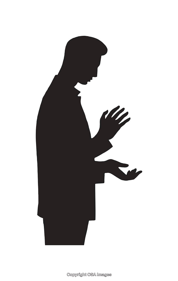 Silhouette of a Man Observing Reverence in a Spiritual Pose