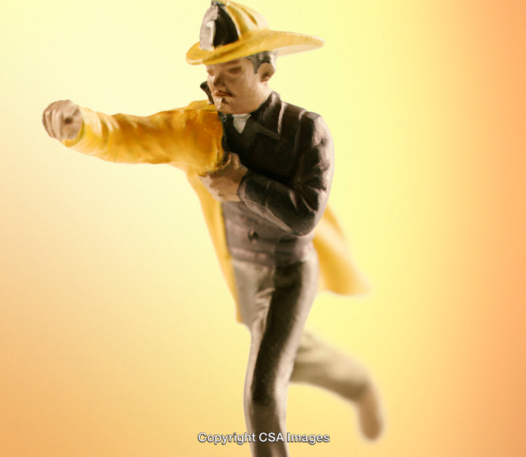 Close-Up of Firefighter Figurine on a Gradient Background