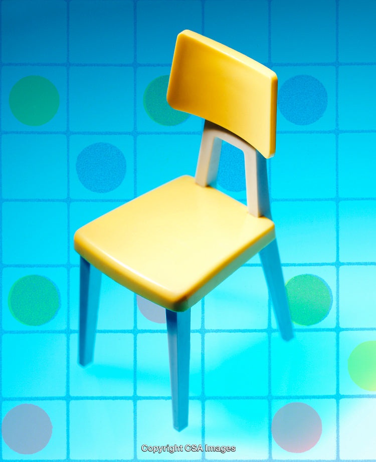 Yellow Toy Chair on Vibrant Colorful Background with Blue Tones