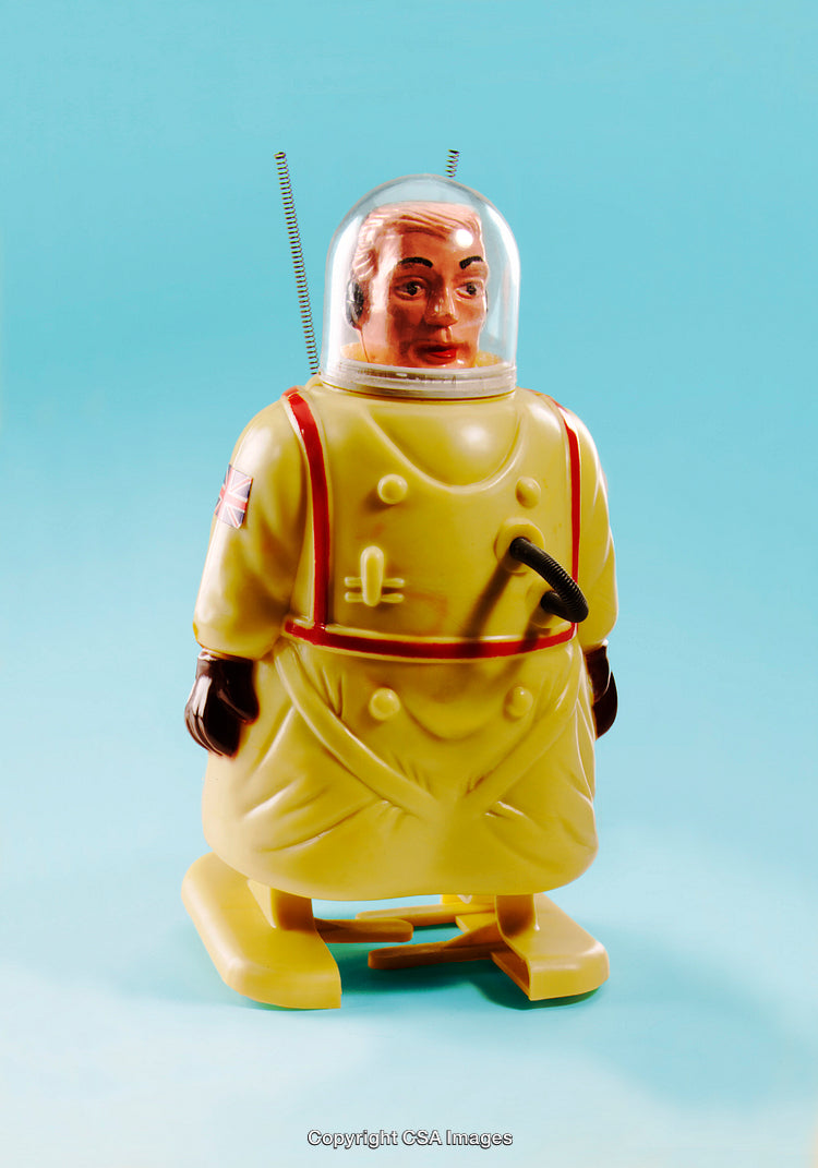 Retro Styled Plastic Toy Spacesuit Action Figure on Light Blue Background