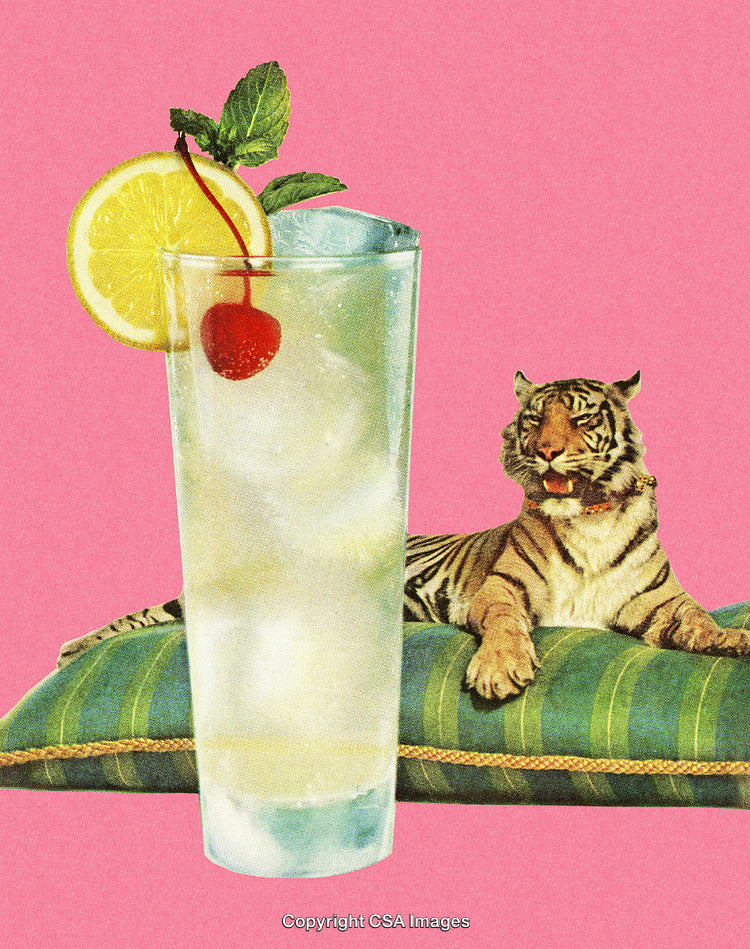 Refreshing Cocktail with Lemon Garnish and Resting Tiger on Pink Background