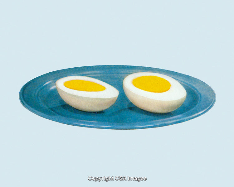 Halved Boiled Eggs Displayed on a Minimalistic Blue Plate