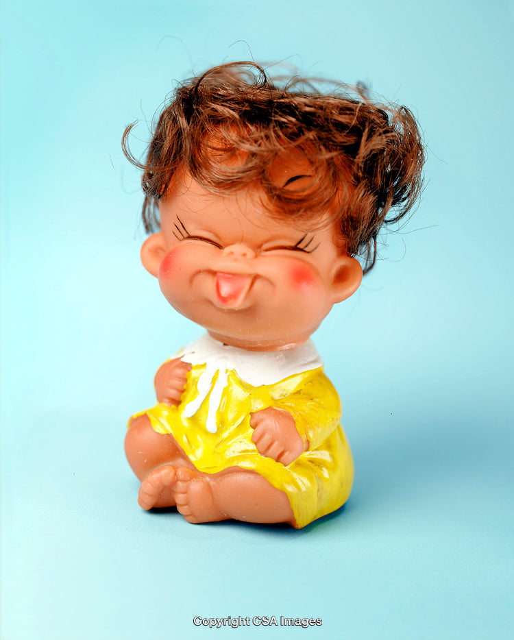 Adorable Plastic Figurine of a Smiling Child Wearing Yellow Dress