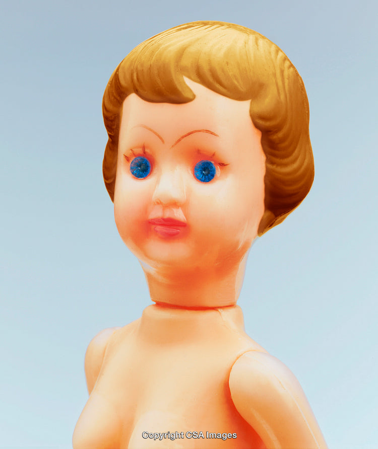 Close-Up of Vintage Plastic Doll With Blonde Hair and Blue Eyes