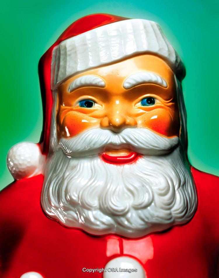 Close-Up of a Vibrant Santa Claus Figurine on Green Background