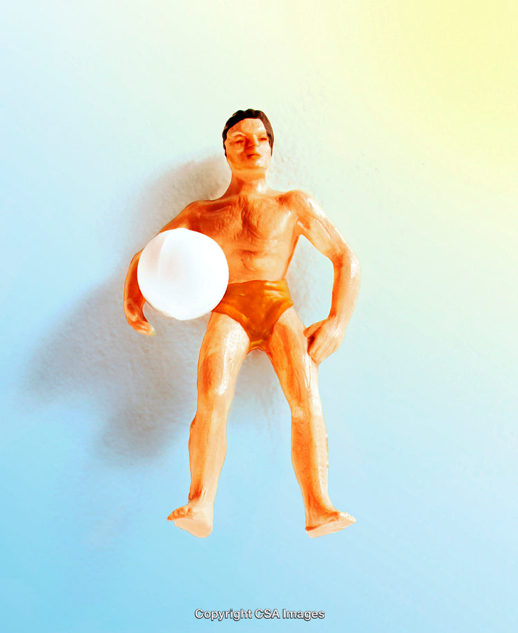 Plastic Toy Figure Holding Ball Against Vibrant Gradient Background