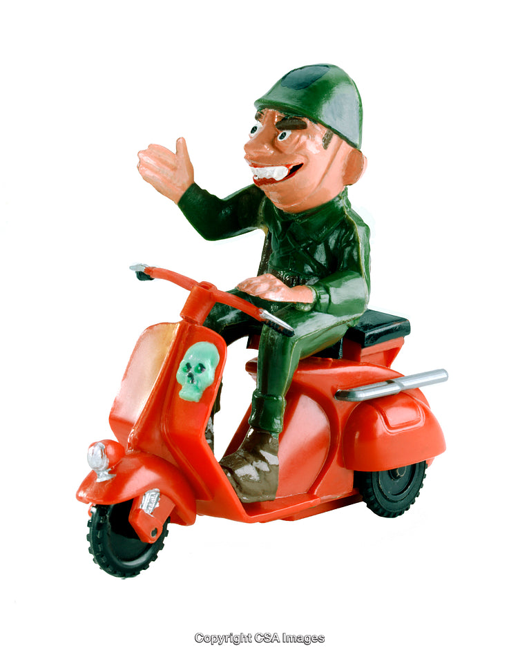 Colorful Toy Soldier Riding Red Scooter with Skull Design