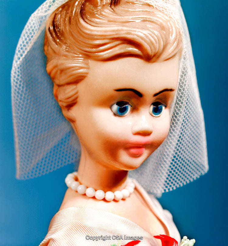 Close-Up of Vintage Bride Doll with Veil and White Pearl Necklace
