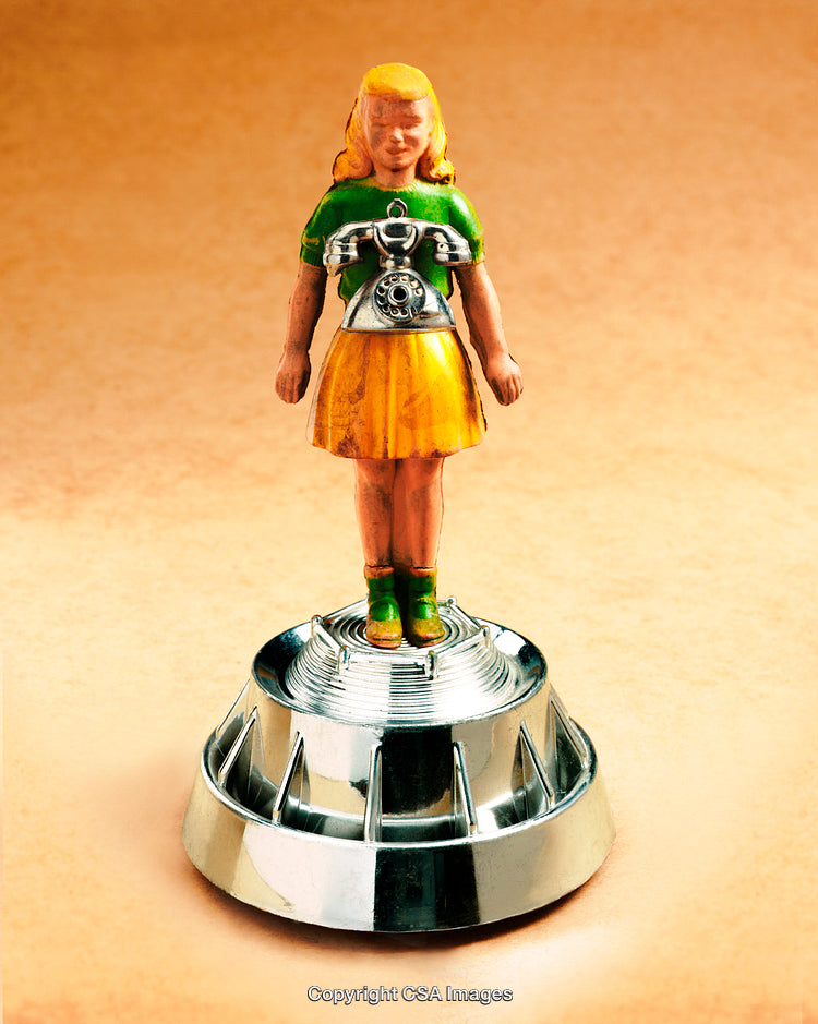 Toy Figurine of a Girl with a Vintage Telephone Design on Pedestal