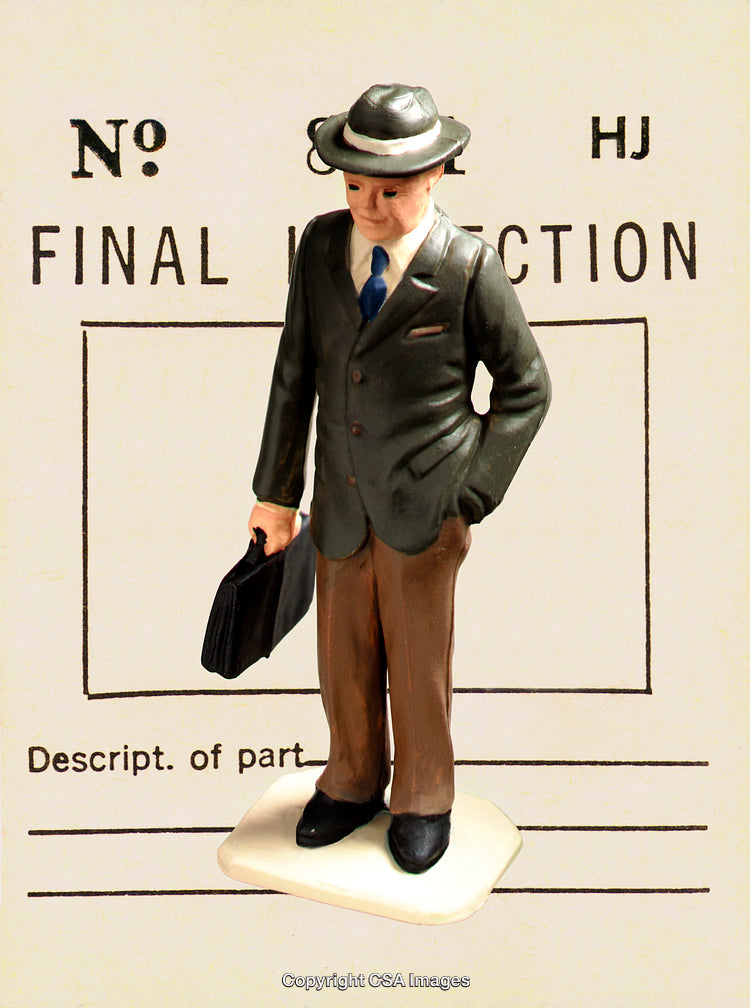 Vintage Figurine of Businessman with Briefcase on Inspection Form Background