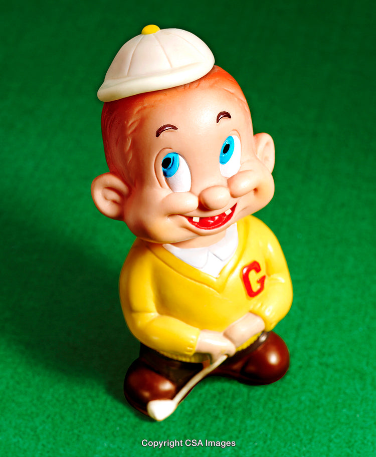 Colorful Vintage Toy Figure of a Smiling Character on Green Background