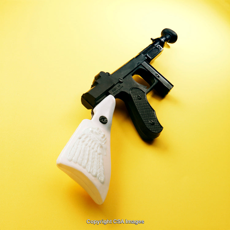 Vintage Plastic Toy Gun with Unique Design on Yellow Background