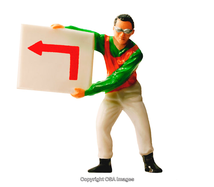 Toy Figure Holding a Sign with a Left Turn Arrow