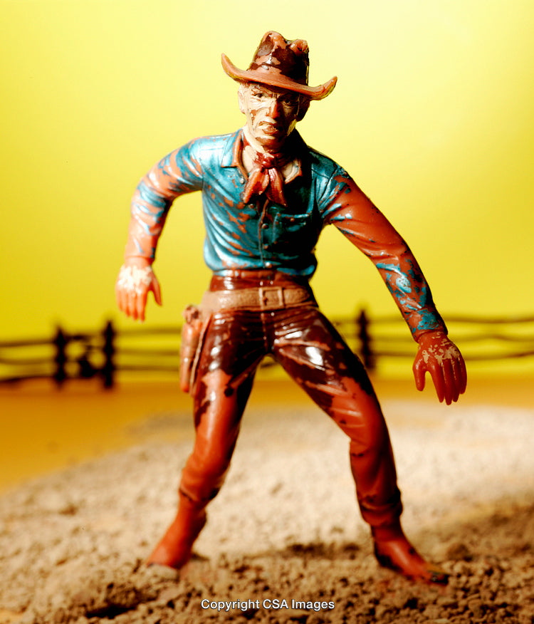 Vintage Cowboy Toy Figurine Against Yellow Background for Wild West Themes