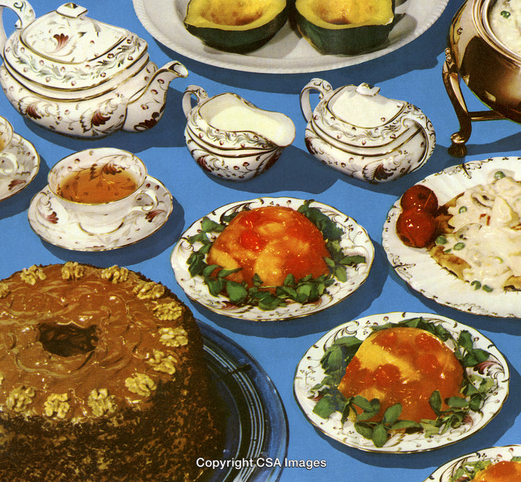 Vintage Tea Set and Desserts Arranged on Blue Background