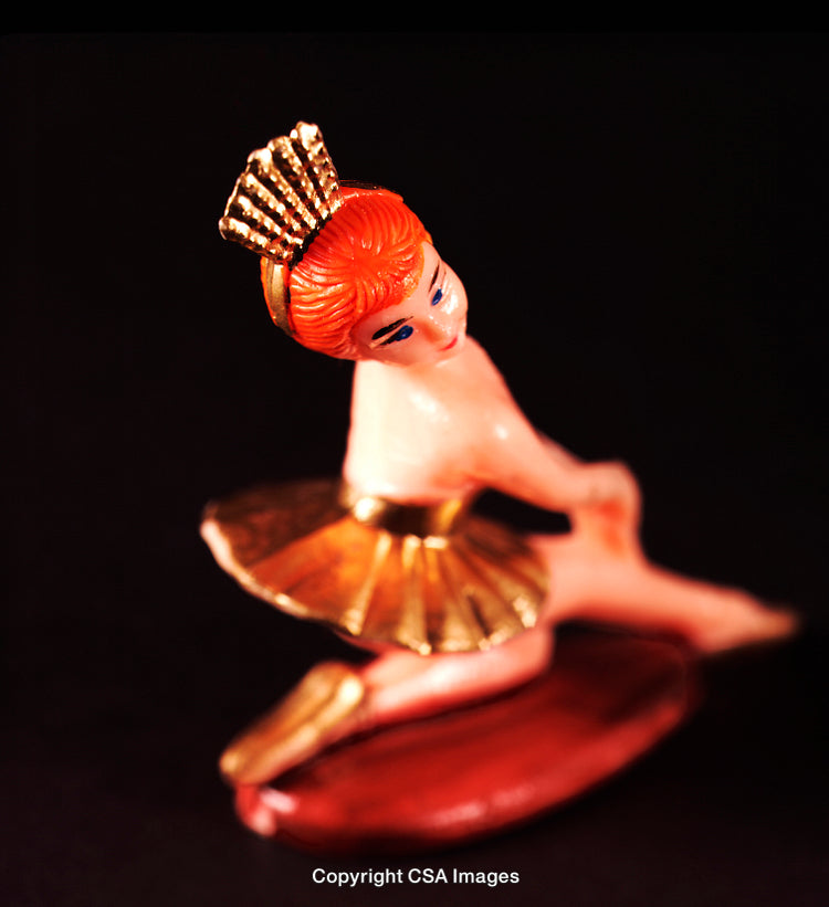 Vintage Plastic Ballerina Figurine With Golden Details and Crown on Black Background