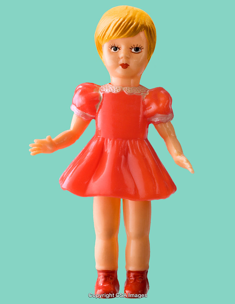 Vintage Plastic Doll with a Red Dress Against Solid Background