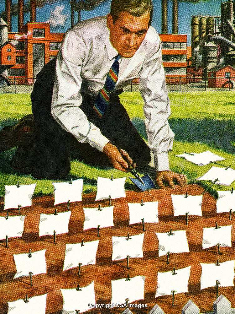 Man Outdoors Planting Small Objects in Soil Near Industrial Landscape