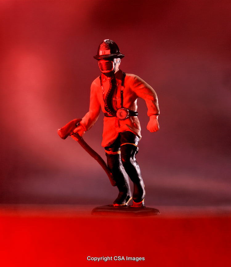 Plastic Firefighter Figure Against a Dramatic Red Background