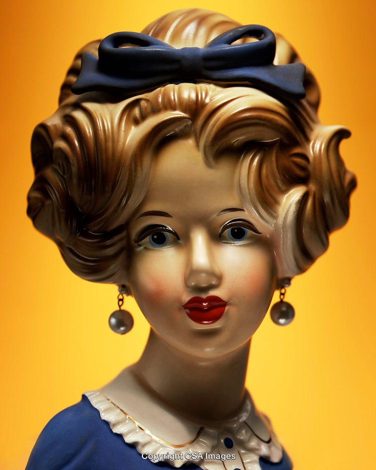 Vintage Figurine of a Woman with Elegant Hairstyle and Pearl Earrings