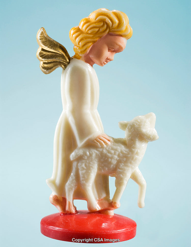Angel Figurine with Lamb on Red Base Against Blue Background