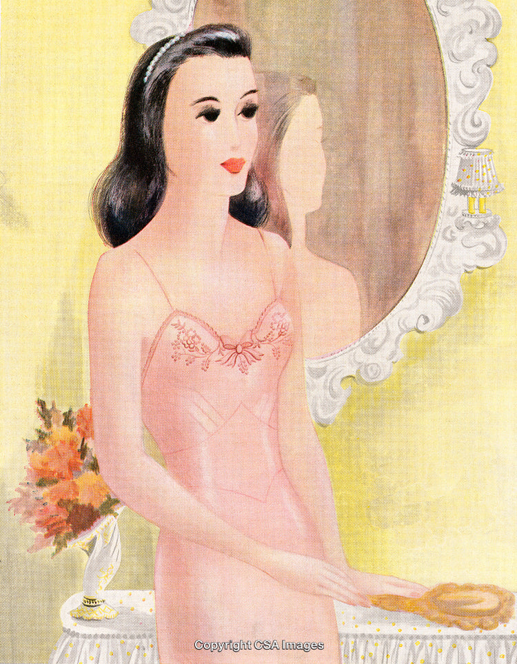 Elegant Woman in Pink Attire Reflecting by a Decorative Mirror