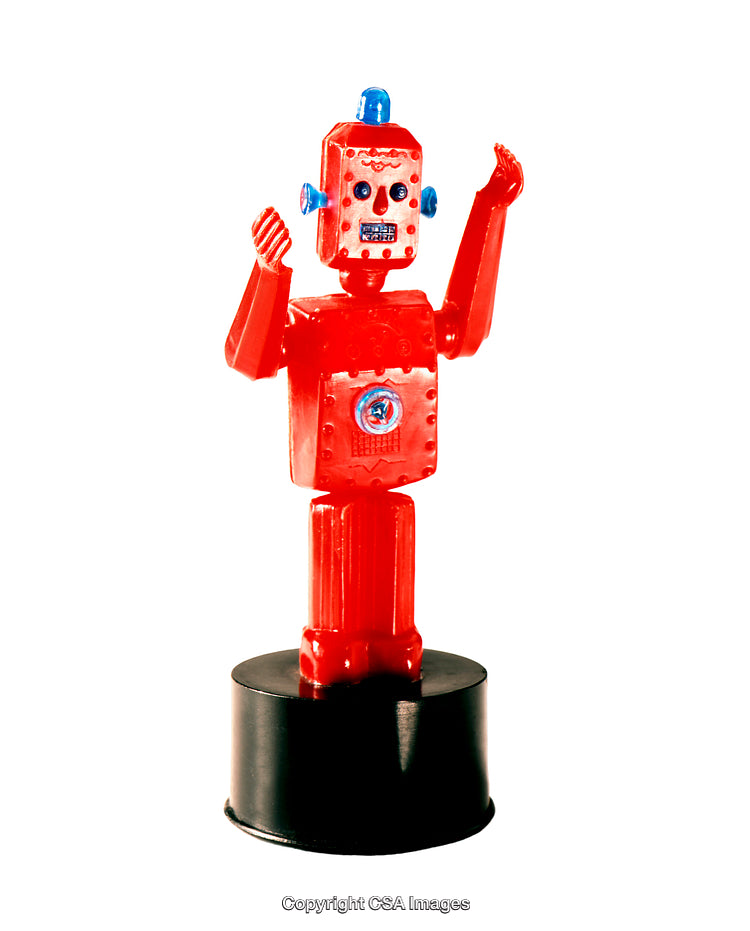 Red Plastic Robot Toy Standing on a Black Base