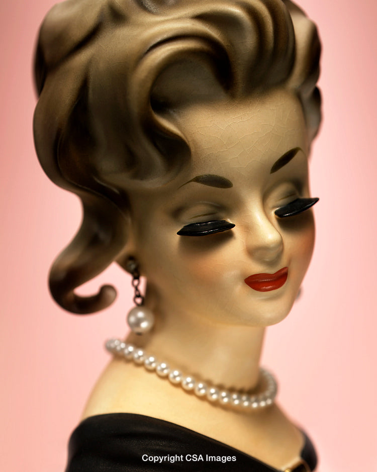 Elegant Retro Figurine Portrait with Pearl Necklace on Pink Background