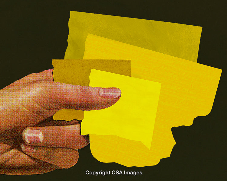 Human Hand Holding Yellow Sticky Notes Against Dark Background