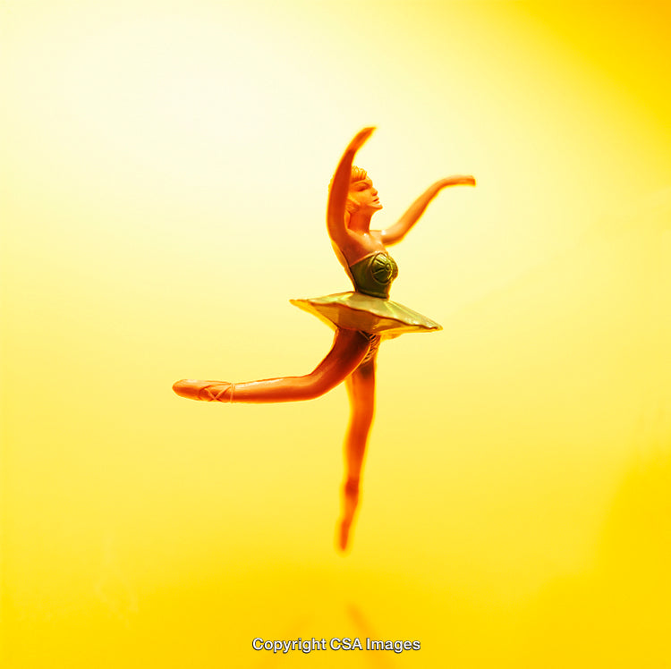 Elegant Plastic Ballerina Figure in Effortless Dance Pose on Yellow Background